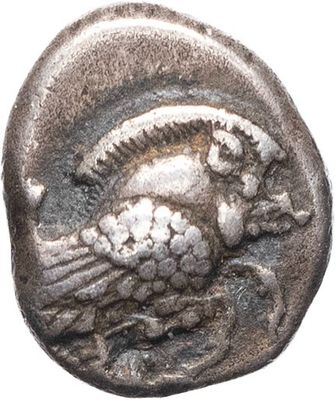 a close up of a coin with a bird on it