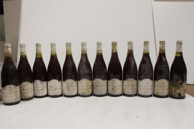 several bottles of wine are lined up in a row on a table