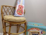 a small chair with a guitar on it next to a box of music