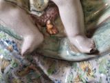 a figurine of a baby sitting on a plate