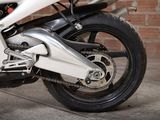 a close up of a motorcycle parked in front of a brick wall