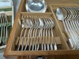 many spoons and silverware in a wooden box