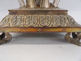 a silver plate with a clock on top of it