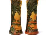 two vases that are sitting on a white surface