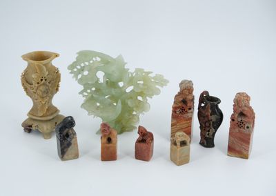 seven pieces of carved figurines sitting next to each other