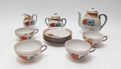 five cups and a teapot on the table