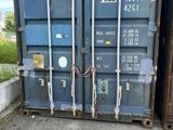 a blue shipping container sitting on the side of the road