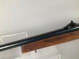 the rifle is on display in a clear display case