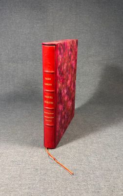 an image of a red book with a red cover on a gray surface