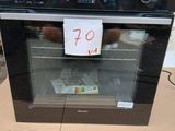 a black oven sitting on a cardboard box with a price tag on it