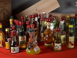 many bottles of alcohol sitting on a red table