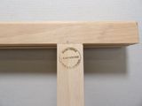 a close up of a wooden cross with a stamp on it