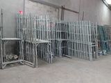 a lot of metal racks in a room with concrete walls