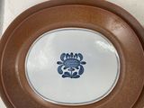 several brown and white plates with blue designs on them on a table