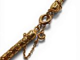 an image of a gold bracelet with a chain attached to it