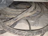 a pile of old and dirty hoses on the floor