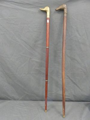 two old canes are sitting next to each other on a gray surface