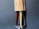 a close up of a wooden handle with a paper bag on it