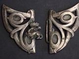 pair of antique silver plated brooches with a lion and a crown on them