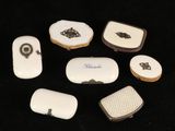 a group of small white and black objects on a black surface