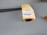 a pipe with a sticker on it next to a pipe holder