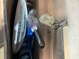 a box with a fan and a cell phone inside of it
