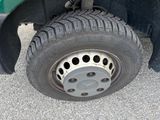 a close up of a tire on a green truck