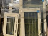 many windows sitting on a pallet in a warehouse
