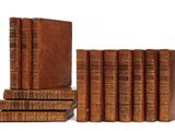 books are stacked on top of each other on a white surface