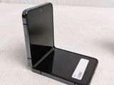 a black cell phone sitting on top of a table