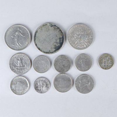 a lot of coins that are on a white surface
