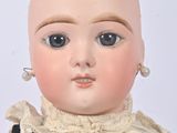 a close up of a doll with a bald head