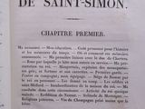 an open book with french writing on it sitting on top of a table