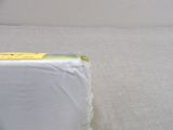 a box of toilet paper sitting on a bed