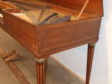 a piano that is sitting on a stand in a room