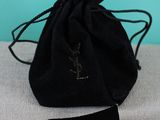 an image of a small black bag with a tag on it
