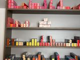 a shelf with many different colored lipsticks on it