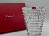 un vase en verre posé à côté d'une boîte rouge