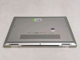 a silver laptop with a green sticker on it