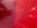 a close up view of a red car with a black top