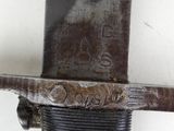 a close up of a metal object with a knife on it
