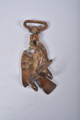 a bird on a keychain hanging on a wall