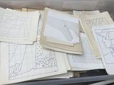 a lot of drawings in a box on the ground