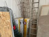 a pile of construction materials in a room with a ladder