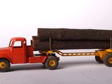 a toy truck with a log on the back of it