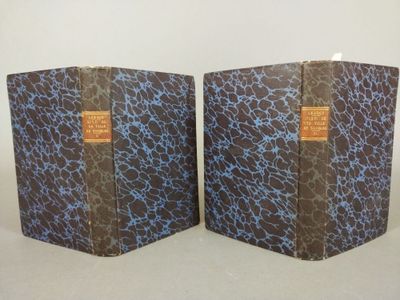 pair of two books sitting on top of each other on a table
