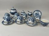 blue and white porcelain tea set with teapots, cups, saucers and spoons
