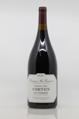 the bottle of wine is sitting on a white surface