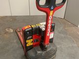 a picture of a red and black machine on a concrete floor