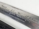 a close up of a large knife on a table